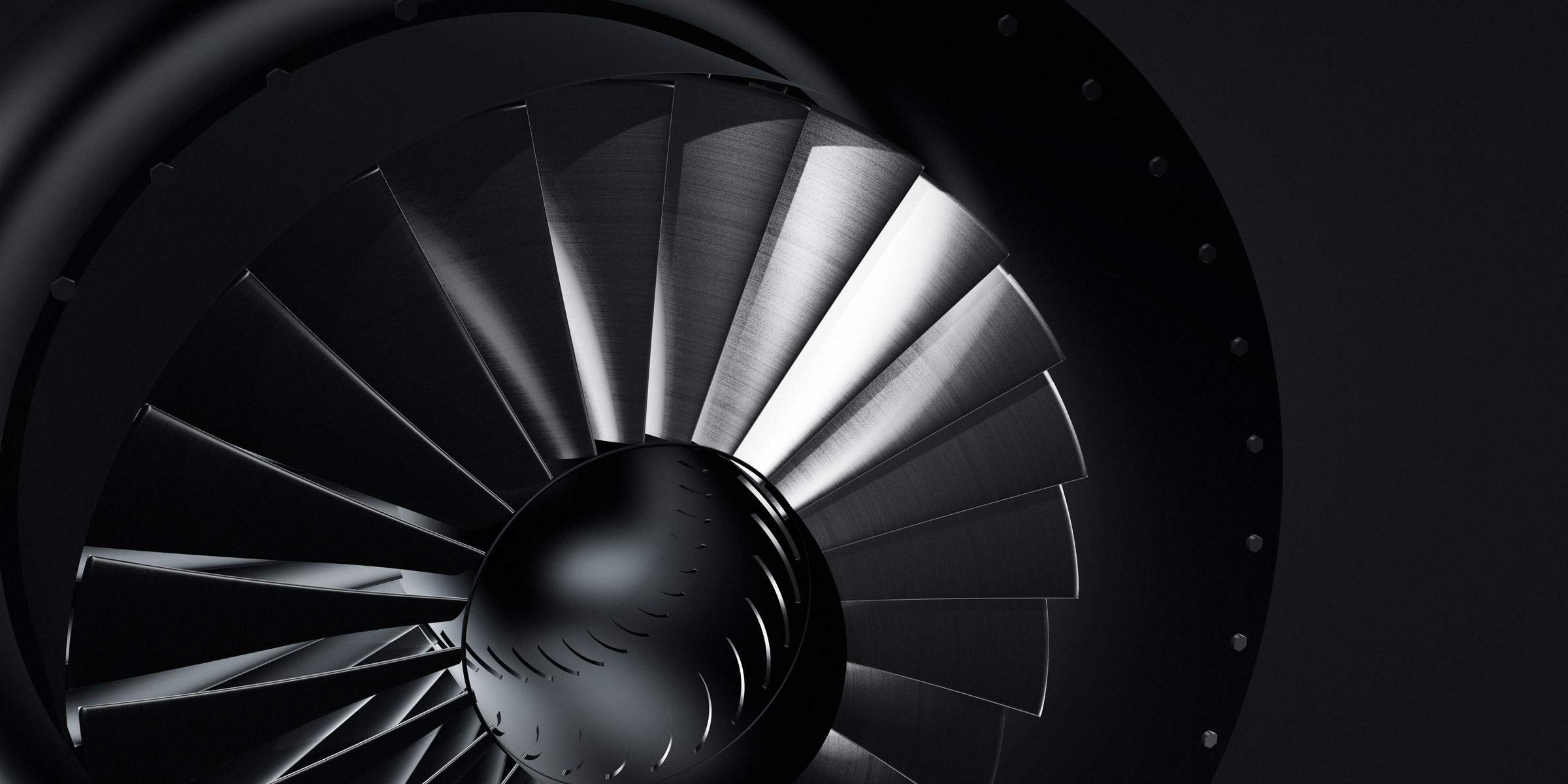 Close view of metal fan blades and the hub of an axial fan stage